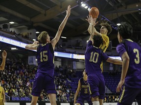 Burnaby South's Emir Krupic tries to shoot over a gaggle of Vancouver College defenders in Friday's Quad A semifinal at the Langley Events Centre. Burnaby South won 69-52 and faces Kelowna in the final tonight.