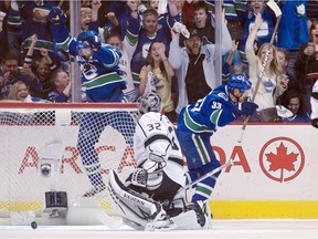 The only time they would celebrate: Canucks Daniel (left) and Henrik Sedin after combining on the only goal the team would score on Kings goalie Jonathan Quick in Game 5 of their opening-round Stanley Cup playoff series at Rogers Arena on April 22, 2012.