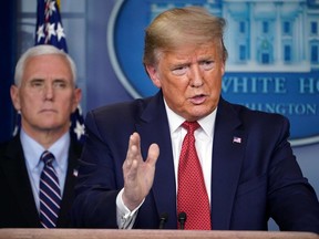 U.S. President Donald Trump speaks at a press conference on the COVID-19 coronavirus pandemic, with Vice President Mike Pence in the background, at the White House in Washington, D.C., on March 25, 2020.