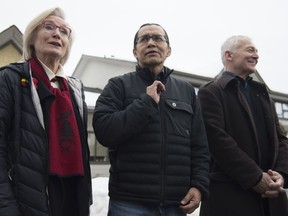 Wet'suwet'en hereditary leader Chief Woos, also known as Frank Alec, centre, Minister of Crown-Indigenous Relation, Carolyn Bennett, left, and B.C. Indigenous Relations Minister Scott Fraser arrive to address the media in Smithers, B.C., Sunday, March 1, 2020.