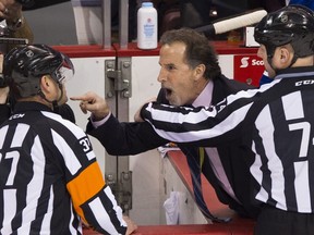 Vancouver Canucks head coach John Tortorella gestures to Calgary Flames players on their bench during a heated NHL game at Rogers Arena on Jan. 18, 2014.