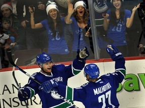 Cody Hodgson, then with the Vancouver Canucks, celebrates a goal against the Detroit Red Wings with teammate Manny Malhotra at Rogers Arena in Vancouver on  Dec. 21, 2011.