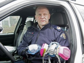 Sgt. Dave Edge of the Richmond RCMP holds a mask and goggles Mounties are wearing to calls during the COVID-19 crisis.
