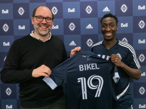 Vancouver Whitecaps sporting director Axel Schuster stands with new signee Janio Bikel at the team's training facility on Tuesday.