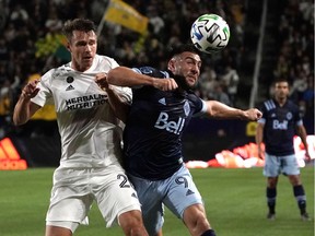L.A. Galaxy centreback Nick DePuy, left, battles with Vancouver Whitecaps forward Lucas Cavallini during  the first half at Dignity Health Sports Park on March 7. The Whitecaps won 1-0.