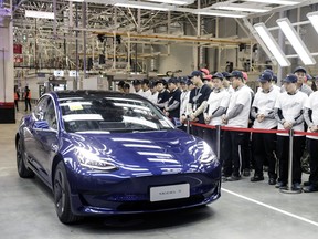 A Tesla Inc. Model 3 vehicle set to be delivered to a company employee moves off an assembly line during a ceremony at the company's Gigafactory in Shanghai, China.