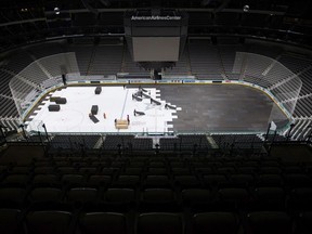 Crews cover the ice at American Airlines Center in Dallas, home of the Dallas Stars hockey team, after the NHL season was put on hold due to coronavirus, Thursday, March 12, 2020.