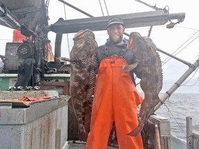 Jeff Belveal from Nanoose Bay holding a pair of lingcod.