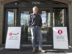 Glenn Bell, owner/general manager of Harrison Pointe, at the entrance to the privately run care home at 21616 52nd Ave. in Langley on April 14. Signs on either side of him indicate that Fraser Health workers are forbidden from entering.