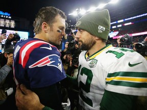 Quarterbacks Tom Brady (left) of the New England Patriots and Aaron Rodgers of the Green Bay Packers meet on the field after the Patriots defeated the Packers 31-17 at Gillette Stadium on Nov. 4, 2018 in Foxborough, Mass.