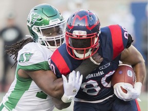 Montreal Alouettes' Spencer Moore, right, is tackled by Saskatchewan Roughriders' Solomon Elimimian during last year's CFL action. Elimimian, the president of the CFLPA, says of his new gig: “You have to be versatile and creative right now. ... So much of this is out of our hands. We have one eye on Ottawa with Trudeau and one on Washington with Trump.”