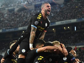 Kyle Walker of Manchester City joins in as Kevin De Bruyne of Manchester City celebrates with teammates after scoring his team's second goal during the UEFA Champions League round of 16 first leg match between Real Madrid and Manchester City at Bernabeu on February 26, 2020 in Madrid, Spain. (David Ramos/Getty Images)