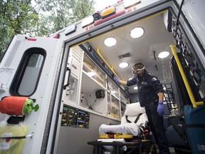 B.C. Ambulance paramedic Jeff Booton cleans his ambulance at station 233 in Lions Bay, B.C. Wednesday, April 22, 2020. Booton was among the people who cared for a COVID-19 patient. The doctors and nurses who care for the critically ill already understand death is a reality. But COVID-19 has added an emotional burden to their work.