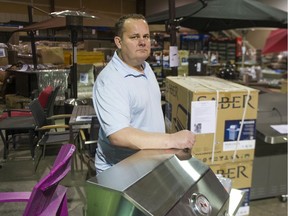 Able Auction owner Jeremy Dodd surrounded by items up for auction. Able Auction has seen a three-fold increase in online attendance since going completely online due to the COVID-19 pandemic.