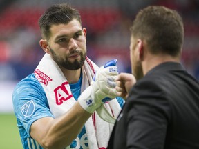 Vancouver Whitecaps goalkeeper Maxime Crepeau fist-bumps head coach Marc Dos Santos after a 3-1 loss to the San Jose Earthquakes at B.C. Place Stadium last July.