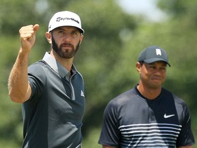 Dustin Johnson (left) with Tiger Woods at the 2018 U.S. Open in Southampton, N.Y. Johnson will team up with Rory McIlroy to take on Rickie Fowler and Matthew Wolff for a $3-million charity skins match this weekend, one of the rare live sports events available as golf adapts to the COVID-19 era.