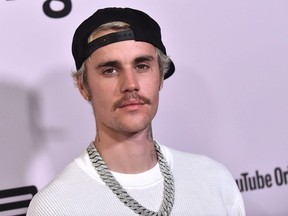 In this file photo Canadian singer Justin Bieber arrives for YouTube Originals' "Justin Bieber: Seasons" premiere at the Regency Bruin Theatre in Los Angeles on January 27, 2020.