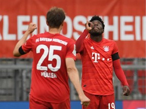 Alphonso Davies celebrates scoring Bayern Munich's fourth goal during their game against Eintracht Frankfurt on Saturday.