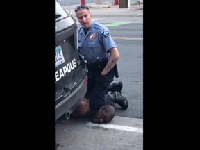 This still image taken from a May 25, 2020, video courtesy of Darnella Frazier via Facebook, shows a Minneapolis, Minnesota, police officer arresting George Floyd.