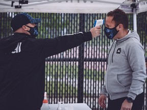Whitecaps coach Marc Dos Santos has his temperature taken before taking the field for the team's first practice last month at UBC.