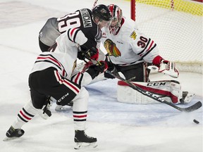 Evan Patrician of the Vancouver Giants digs for the puck in front of Portland Winterhawks goalie Joel Hofer during a WHL game at Langley Events Centre on Nov. 8, 2019.