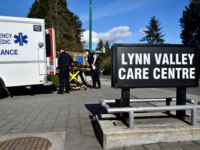 A paramedic removes protective gear outside the Lynn Valley Care Centre, a seniors care home which housed a man who was the first in Canada to die after contracting novel coronavirus, in North Vancouver on March 9, 2020.