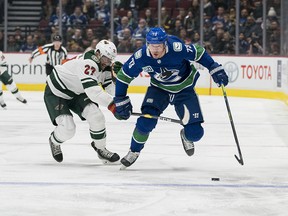 Minnesota Wild forward Alex Galchenyuk checks Canucks forward Tyler Toffoli at Rogers Arena in Vancouver on Feb. 19.