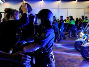 Police use batons to clear protesters from the street following a rally against the death in Minneapolis police custody of George Floyd in Boston, Massachusetts, U.S., May 31, 2020.   REUTERS/Brian Snyder