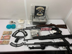 Photo of firearms, patches, cash, and drugs