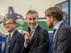 Trevor Linden between fellow former Canucks captains Stan Smyl and Markus Naslund during Canucks Legends Night on February 10, 2020.