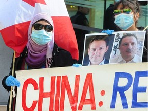 Perhaps most immediately at risk following Wednesday's court ruling are the two detained Canadians in China, Michael Kovrig and Michael Spavor, pictured on a sign carried by protesters outside court.
