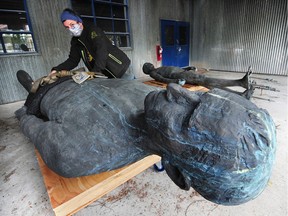 Artist Cheryl Hamilton helps transport Jack Harman's statue 'The Family' from a storage space in Surrey to Granville Island on Thursday. The move from Surrey to Vancouver was delayed because of the novel coronavirus outbreak in March.