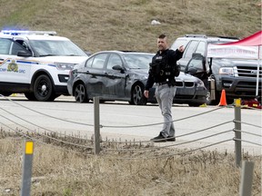 Police officers work at the scene of a shooting involving a police officer along the QEII just north of the Hwy 2A exit, in Leduc, Wednesday, May 6, 2020.