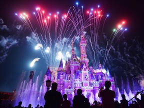 This photo taken on June 16, 2017, shows visitors watching fireworks exploding over the castle at an event to mark the first anniversary of the opening of Shanghai Disneyland, in Shanghai.