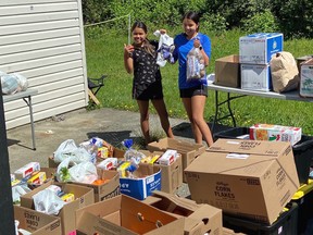 Tessa and Kelsey Jack stand with some of the groceries that Vancouver Whitecaps midfielder Russell Teibert and his teammates helped procure for the Penelakut First Nations band.