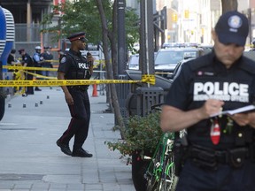 A gun is left behind at the scene as Toronto Police Chief Mark Saunders speaks to the media at the scene of Toronto's latest homicide after 3 people were shot, one person fatally at Peter Street and Wellington in front of the the SoHo Hotel & Residences on Tuesday May 26, 2020. Stan Behal/Toronto Sun/Postmedia Network