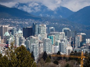 A crane is seen at a condo development under construction as condo and office towers fill the downtown skyline in Vancouver, B.C., on Friday March 30, 2018. The Real Estate Board of Greater Vancouver says commercial real estate activity was down substantially last year from a year earlier, and from the long-term average, on slower economic activity.