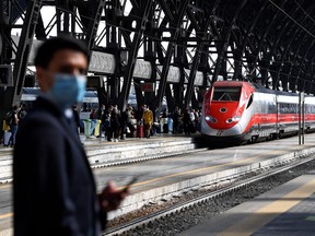 Commuters are seen at a platform at Milan central station, as Italy eases movement between regions as the country unwinds its rigid COVID-19 lockdown, in Milan, Italy June 3, 2020.