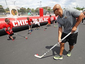 Former NHL player Jamal Mayers gives instructions to children during the 2017 NHL Draft top prospects hockey clinic on June 22, 2017 in Chicago, Illinois. Eric Brewer was a teammate of Mayers in St. Louis and believes that real education to understand race relations starts at home with children.