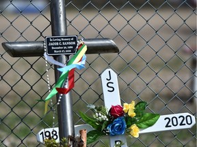 Crosses were placed by family and friends at a ceremony to say goodbye to slain Metis hunters Jake Sansom and Morris Cardinal, north of Glendon, 230 km northeast of Edmonton, May 30, 2020.