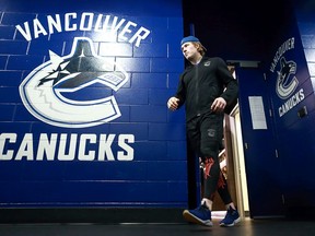 Brock Boeser of the Vancouver Canucks walks out of the Vancouver Canucks dressing room before their NHL game against the Carolina Hurricanes at Rogers Arena on December 5, 2017. Boeser and his Canucks teammates hope to return for the start of training camp on July 10.