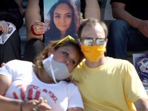 Pictures of Chantel Moore, are held by family and friends during a healing gathering at the B.C. Legislature in Victoria