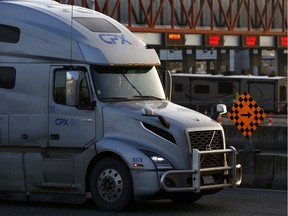 A truck waits in line to U.S. customs to enter into Blaine, Washington, at the truck route border crossing, after additional measures to combat the spread of novel coronavirus disease (COVID-19) were announced, in Surrey, Canada March 18, 2020.