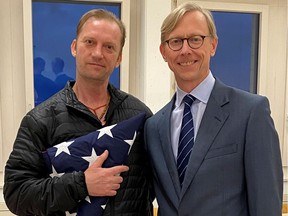 Michael White, a freed U.S. Navy veteran detained in Iran since 2018, poses with U.S. Special Envoy for Iran Brian Hook while on his return to the United States at Zurich Airport in Zurich, Switzerland June 4, 2020.  U.S. State Department/Handout via REUTERS. THIS IMAGE HAS BEEN SUPPLIED BY A THIRD PARTY. THIS IMAGE WAS PROCESSED BY REUTERS TO ENHANCE QUALITY, AN UNPROCESSED VERSION HAS BEEN PROVIDED SEPARATELY.