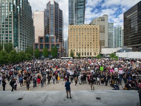 People rally during an anti-racism rally in front of the  Vancouver Art Gallery.