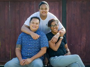 Aaron Tung, with his father Wilson and mother Denise, pose for pictures at their home in Coquitlam. Aaron is packing for Clearwater Academy in Clearwater, Fla. to pursue a football dream during a pandemic and racial unrest.