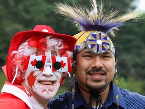 Greg Sturm (left) poses with native dancer Barry Albert during a Canada Day celebration, Monday, July 1, 2013 in London, Ont. Indigenous communities and leaders are sharing their Canada Day frustrations.