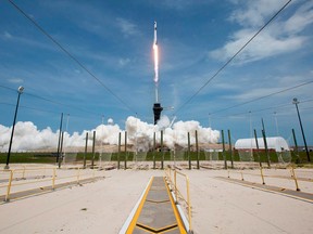 This NASA photo obtained May 31, 2020 shows a SpaceX Falcon 9 rocket carrying the company's Crew Dragon spacecraft launched from Launch Complex 39A on NASAs SpaceX Demo-2 mission to the International Space Station with NASA astronauts Robert Behnken and Douglas Hurley onboard, at 3:22 p.m. EDT on May 30, 2020, at NASAs Kennedy Space Center in Florida.
