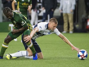 Portland Timbers midfielder Diego Chará and Vancouver Whitecaps midfielder Andy Rose battle for control of the ball during their 2019 meeting at Providence Park, won 3-1 by the Timbers. Should Rose see the field Sunday along with Fredy Montero, the two former Sounders will be the first players to host Cascadia Cup games in each of the three clubs' parks.