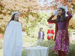 Amaris Han (left), the 2019 May queen, watches as Sienna Vahra — the 150th New Westminster May queen — tries on her new crown for size in a modest, appropriately socially distanced May 20 ceremony.